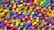 A vibrant array of multicolored 3D cubes stacked closely together in a random pattern. The cubes display a range of bright colors, creating a dynamic and lively visual effect.