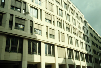 Modern office facade featuring large windows treated with discreet security films, reflecting the Austin skyline.