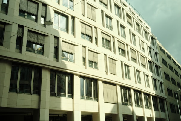 Completed commercial office building with glass facade in daylight