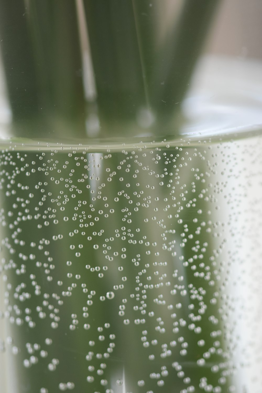 a close up of a glass with water droplets