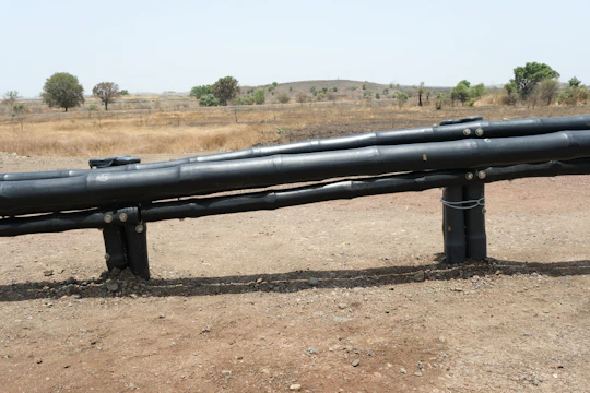 Aerial view of newly laid water distribution pipelines weaving through Shinas residential areas.