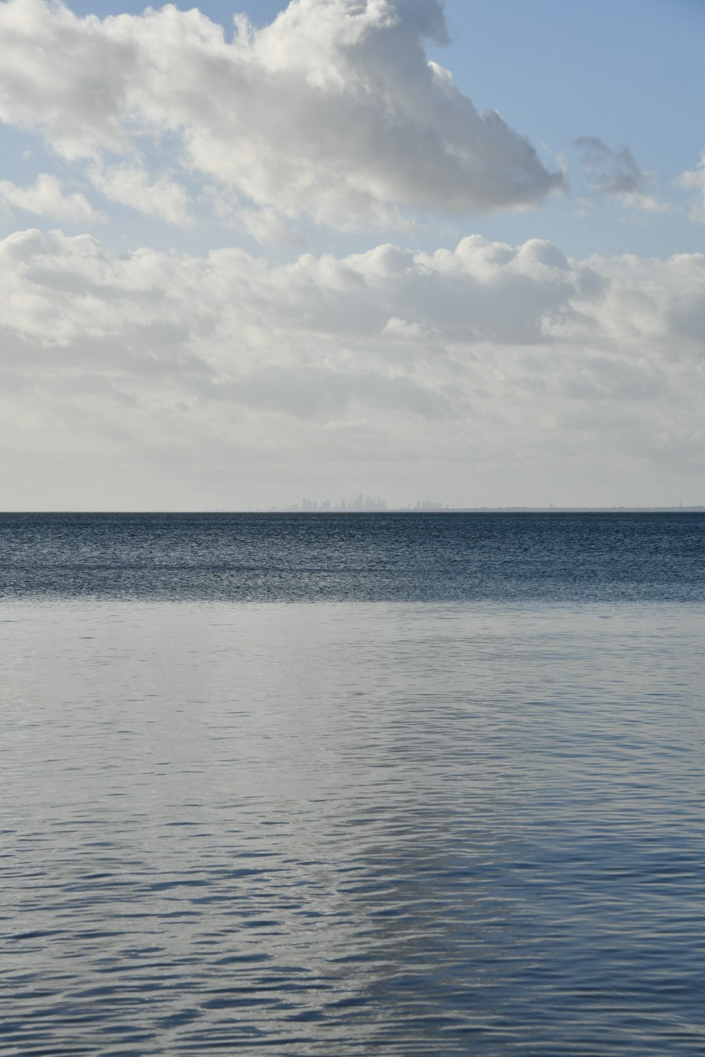 a large body of water under a cloudy sky