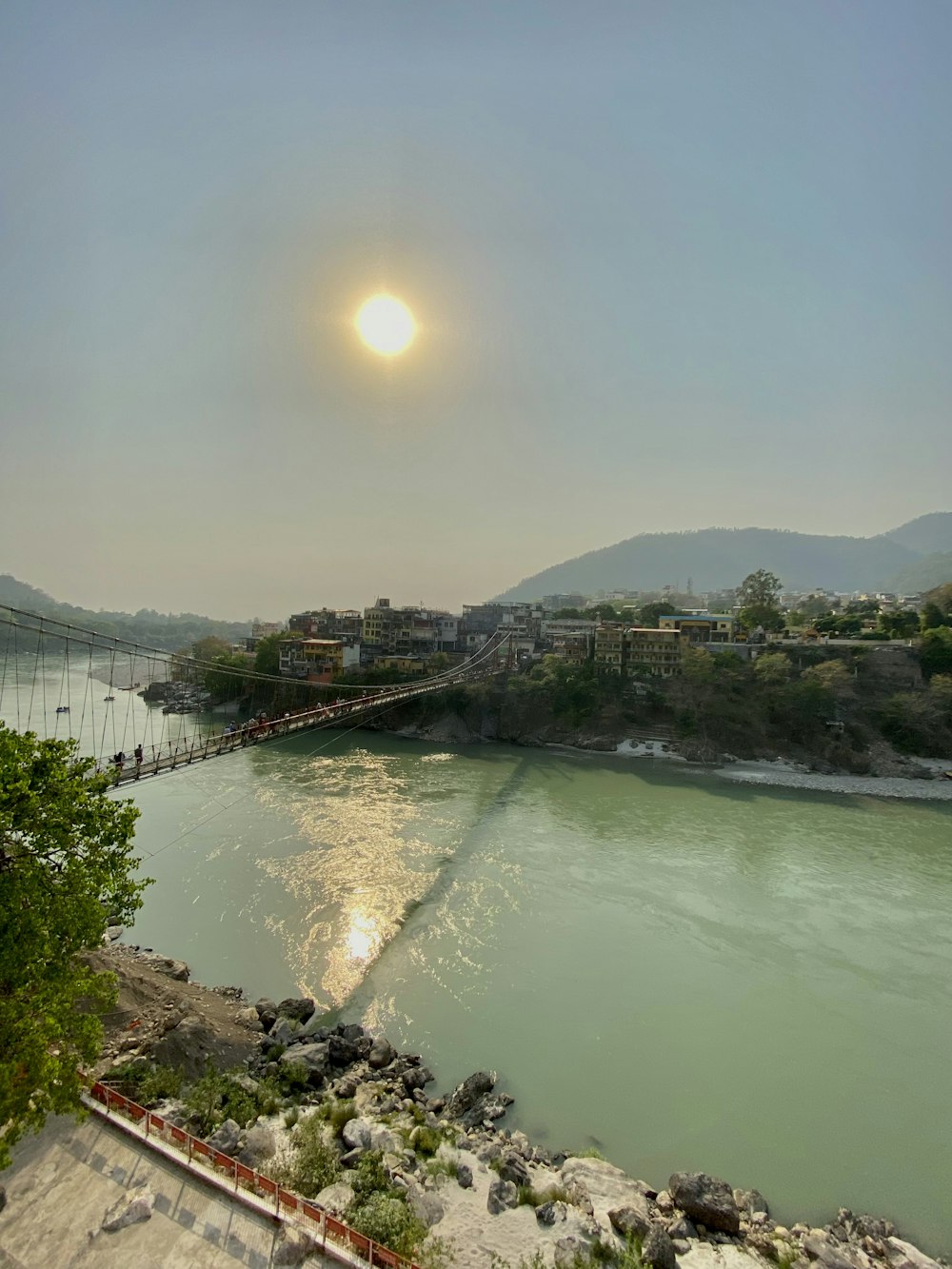 a body of water with a bridge in the background