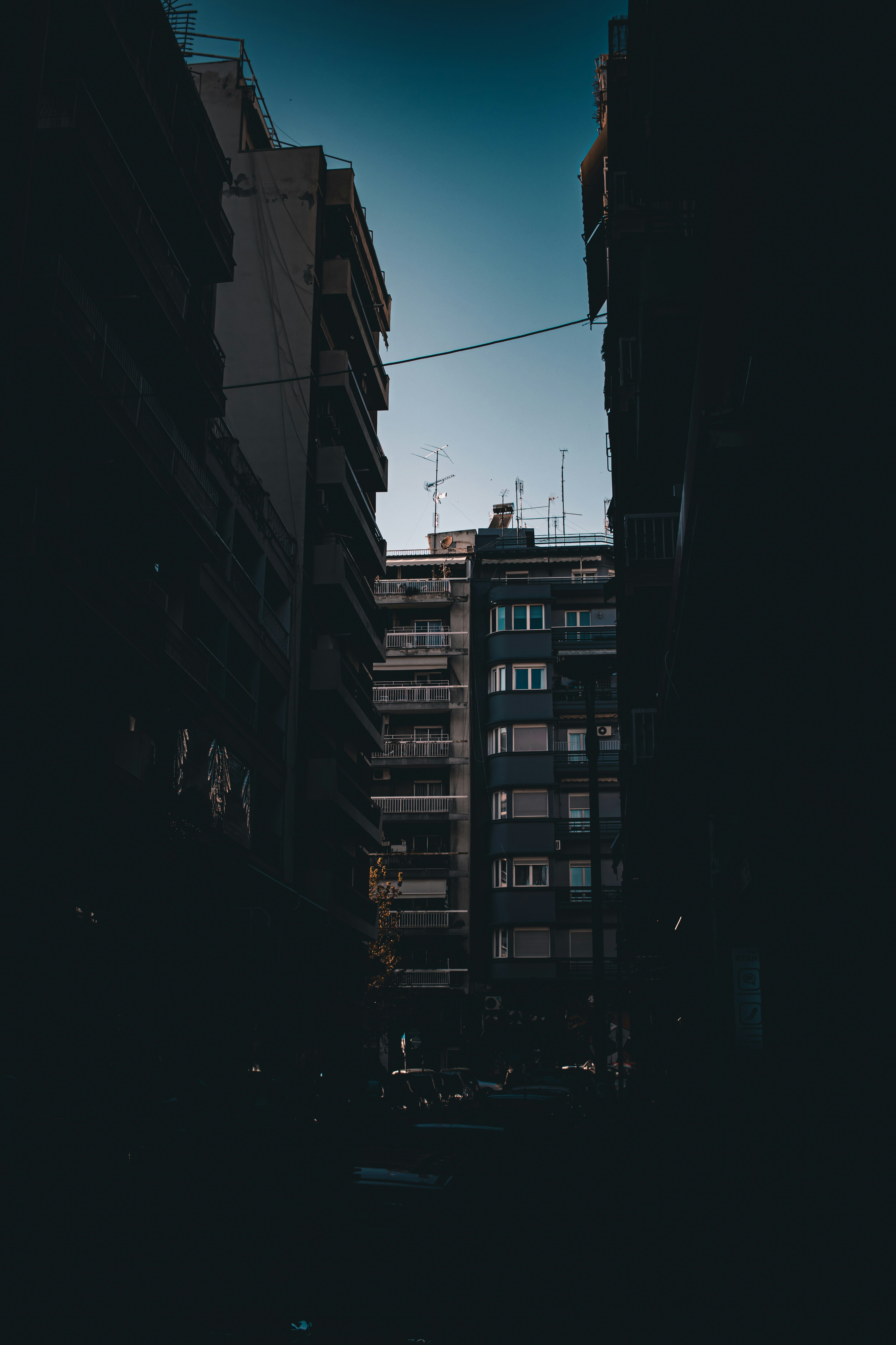 a city street with tall buildings in the background