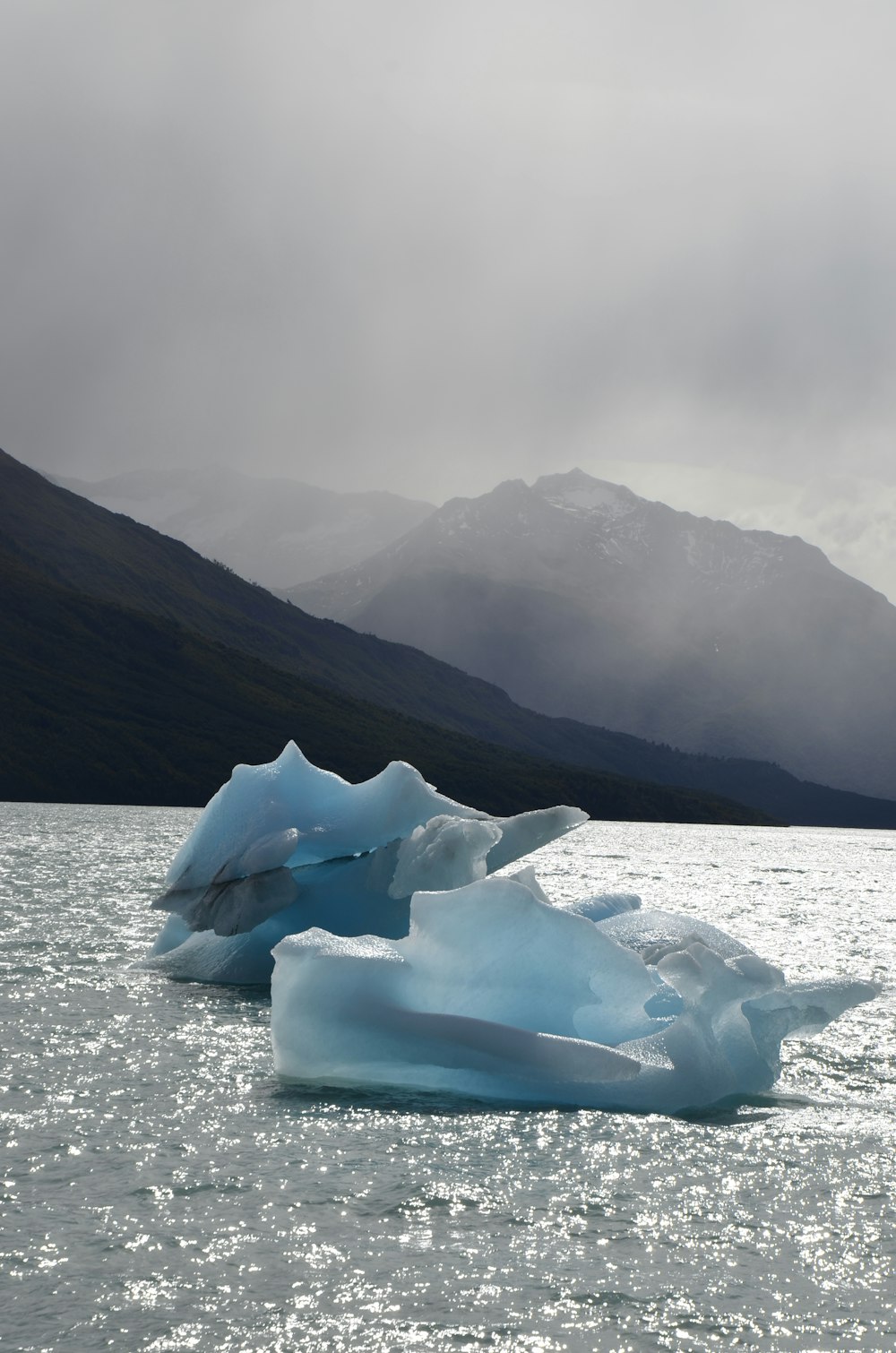 a large iceberg floating on top of a body of water