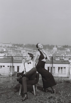 An elegant couple enjoying a quiet moment at a chic London rooftop venue.