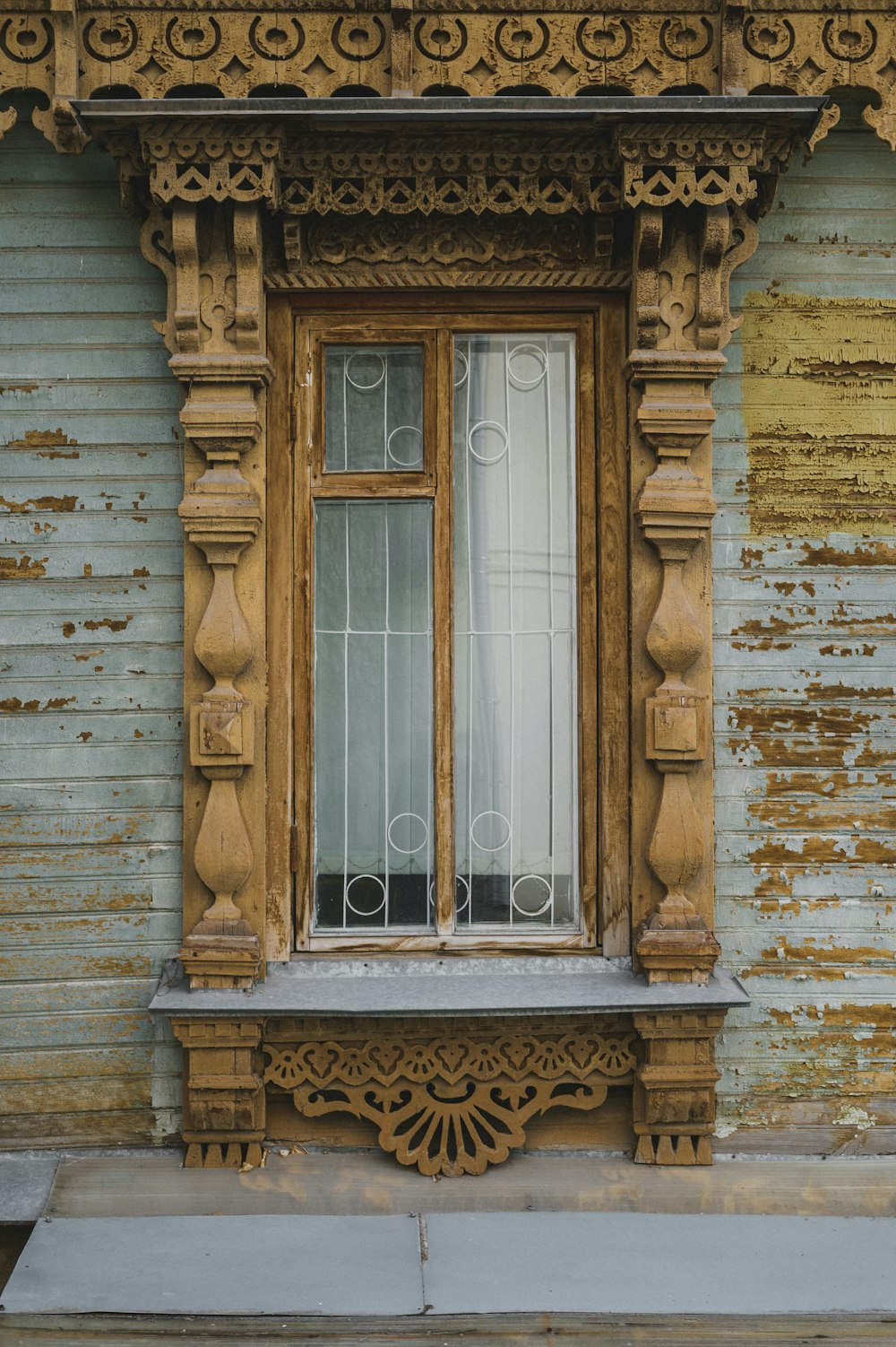 a wooden window on the side of a building