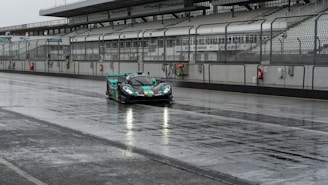 A sleek Formula 1 car speeding through a rain-soaked track under dramatic stormy skies.