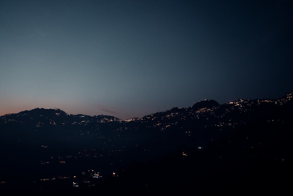 a view of a mountain at night from a distance