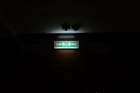 An emergency exit sign illuminated in a dim corridor.