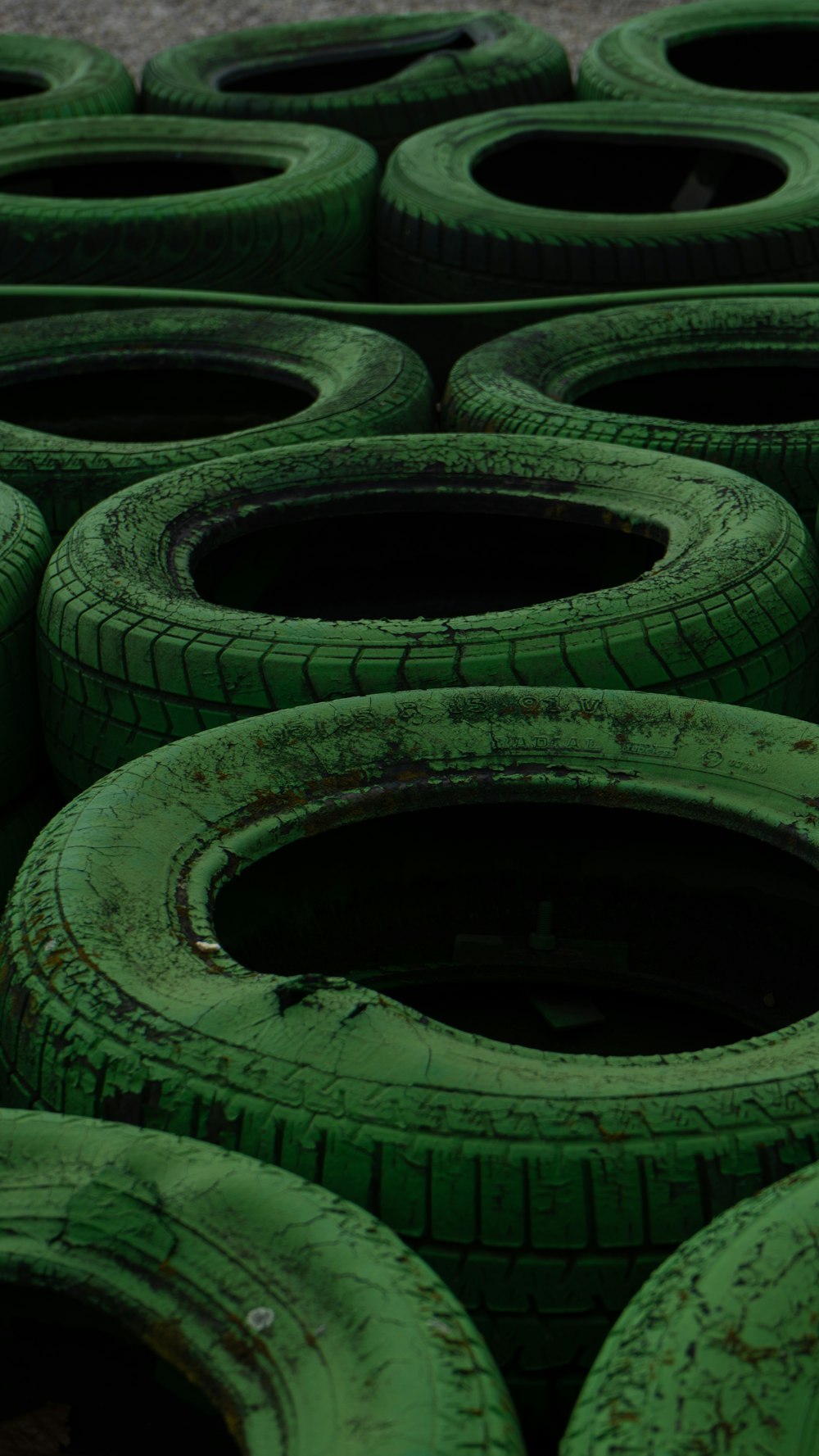 a pile of green tires sitting next to each other