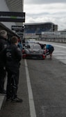 A group of drivers preparing for a service on a sunny day.