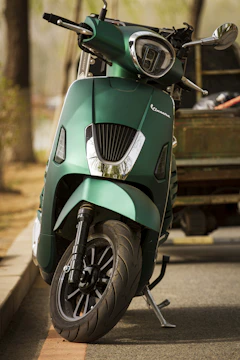 Close-up of a sleek electric scooter parked near a busy Chennai street.