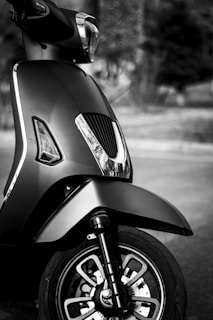 High-quality studio shot of a motu scooter against a black and silver minimal backdrop