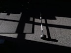 Close-up of weights and training bands laid out neatly on a gym floor with natural light.