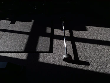 Sunlight streaming through the gym windows as athletes push through a tough WOD together.