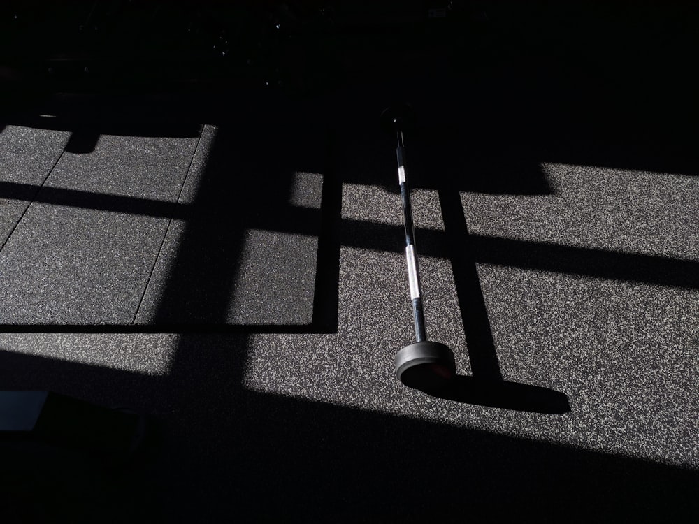 the shadow of a golf club on the ground