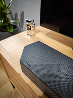 A finished industrial prototype displayed on a sleek wooden table