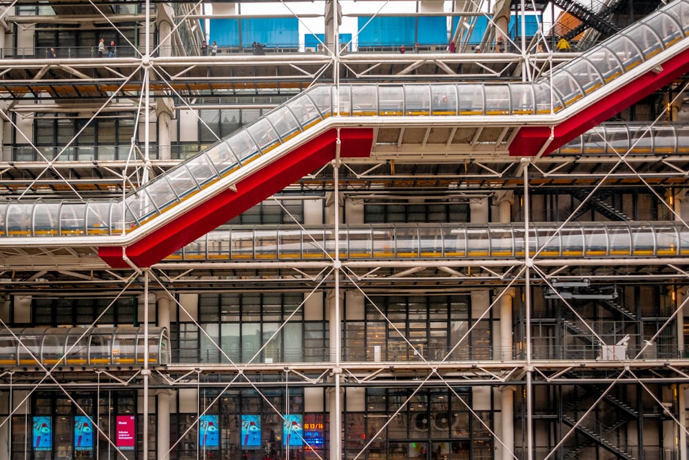 a large building with scaffolding and a red and white staircase