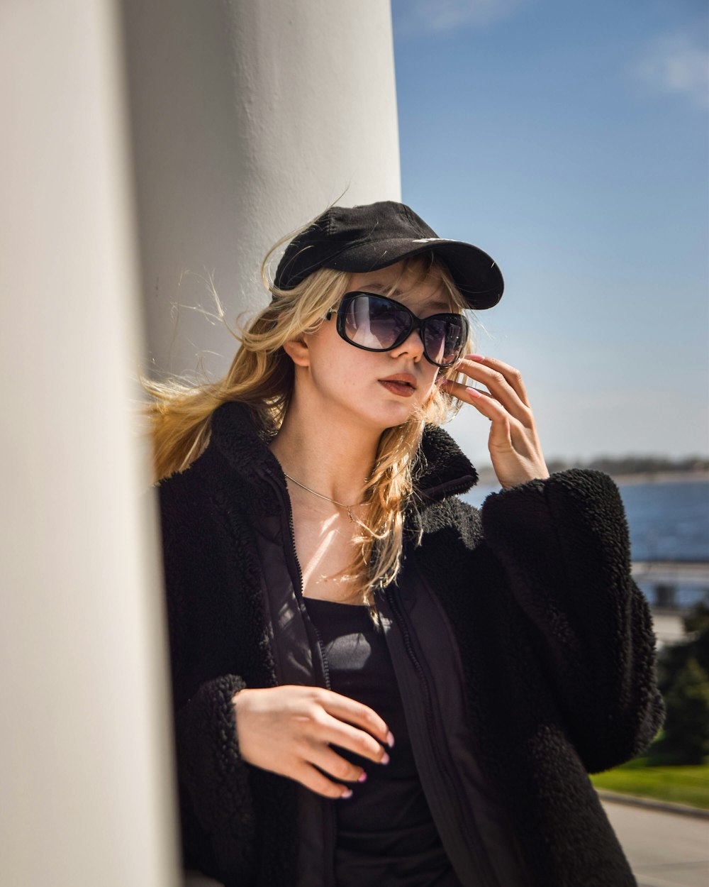 a woman wearing sunglasses and a black hat