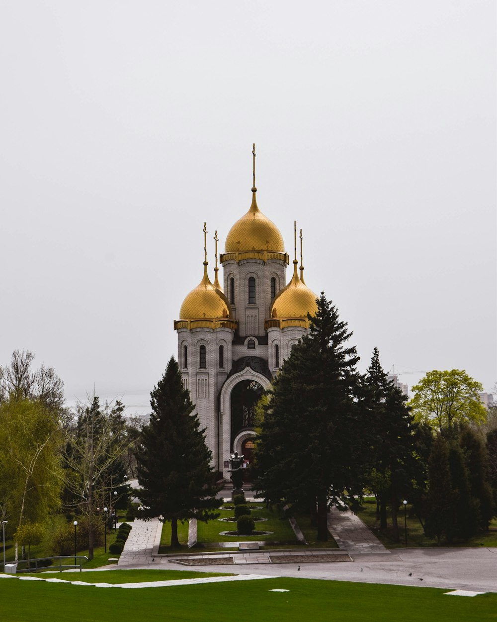 a large white building with gold domes on top of it