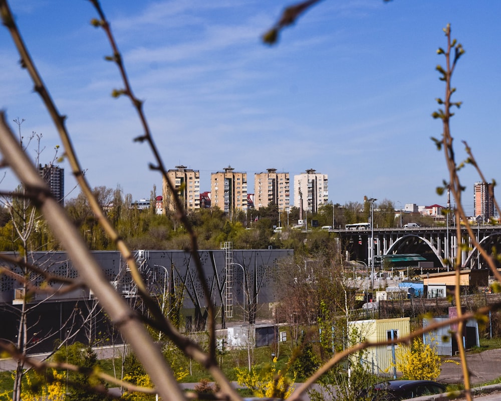 a view of a bridge over a river with buildings in the background