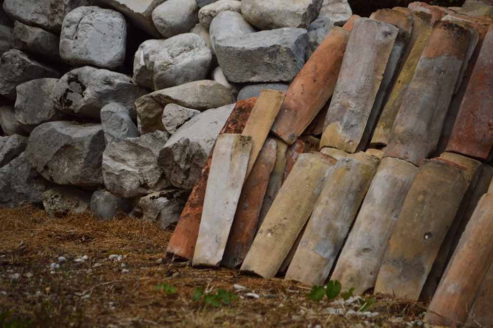 a pile of wood sitting next to a pile of rocks