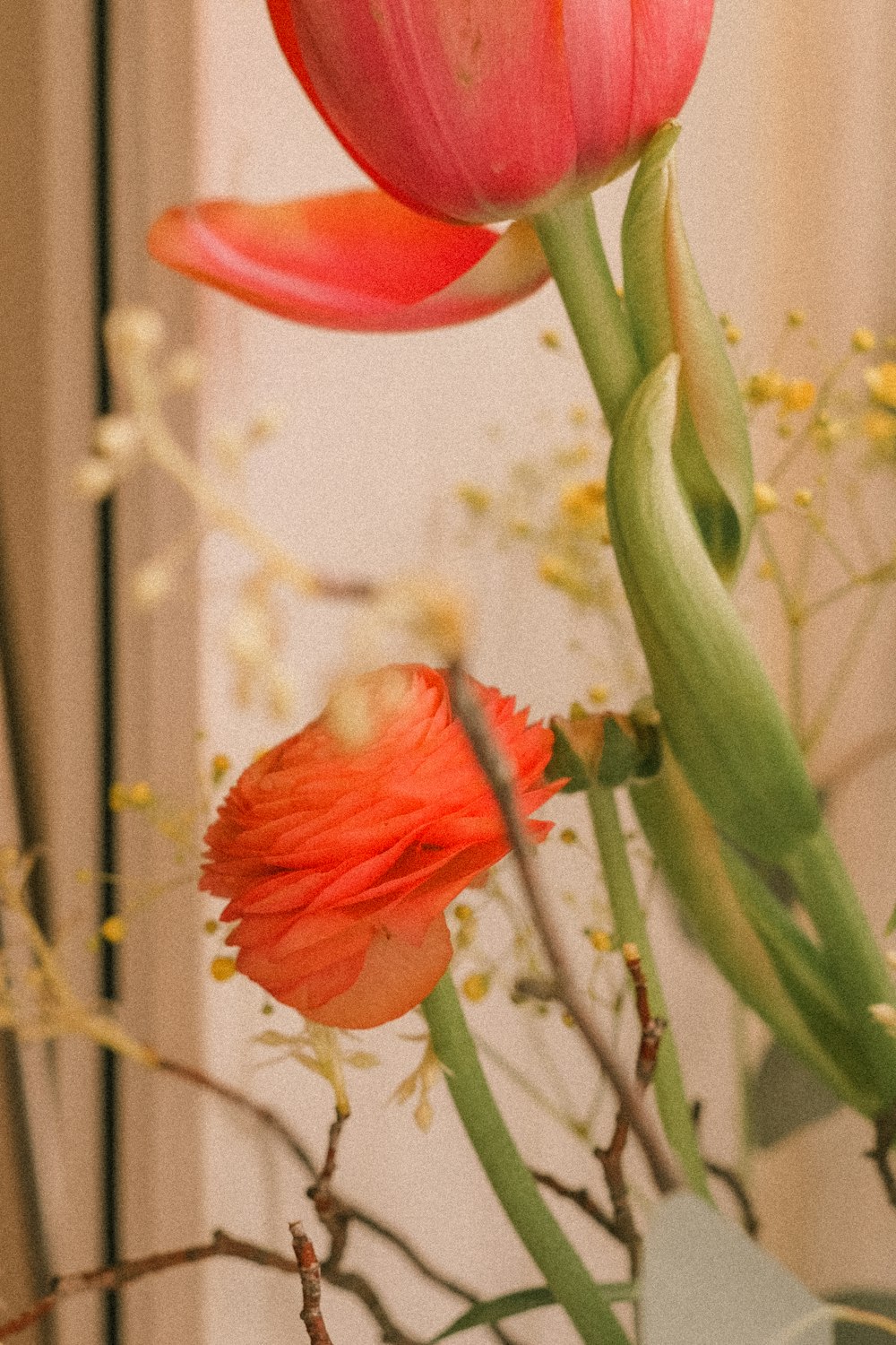 a vase filled with pink flowers on top of a table