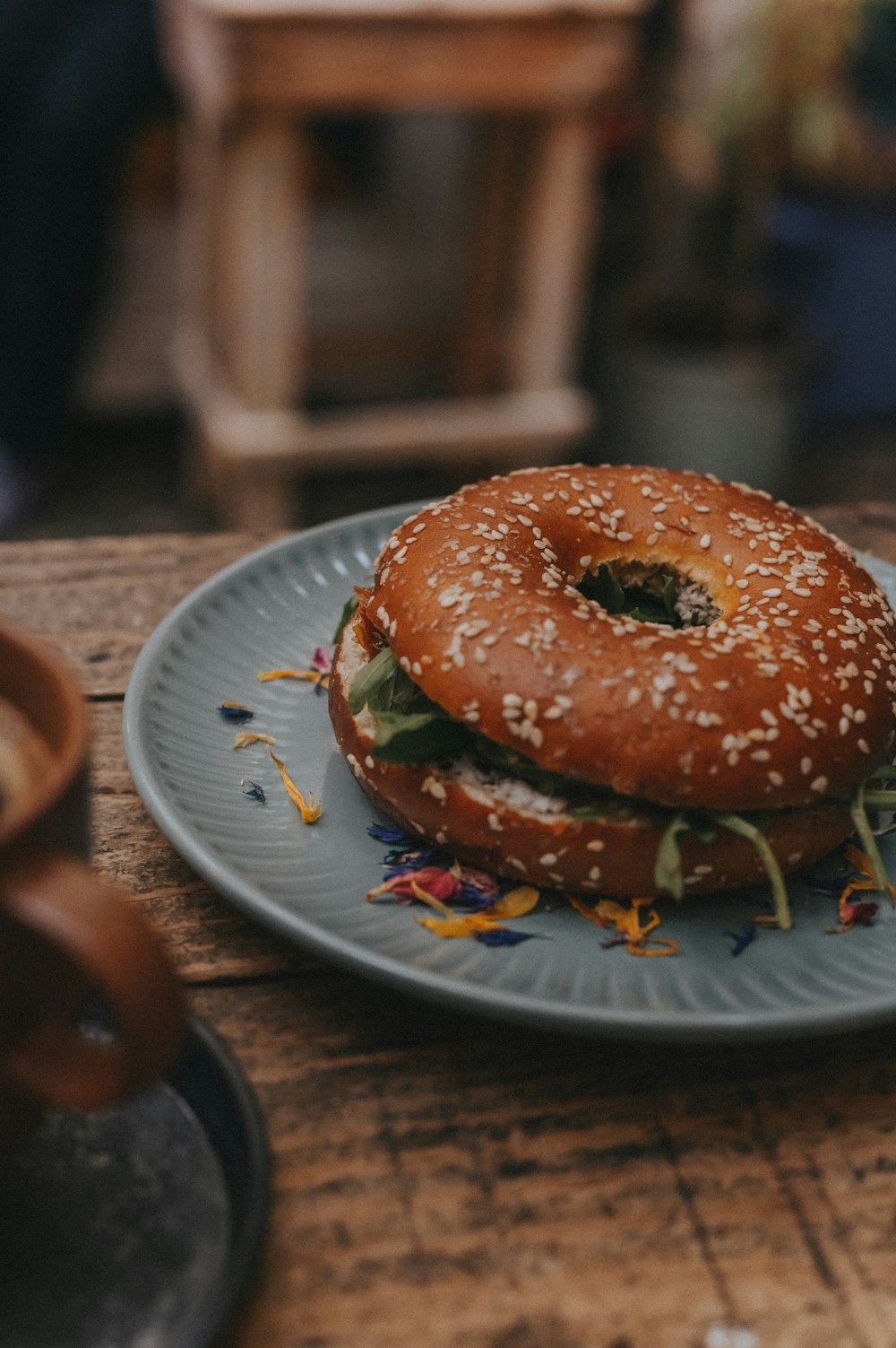 a bagel sandwich sitting on top of a blue plate