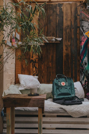 A cozy indoor setting with emberleaf cannabis products displayed on a wooden table beside a cup of tea.