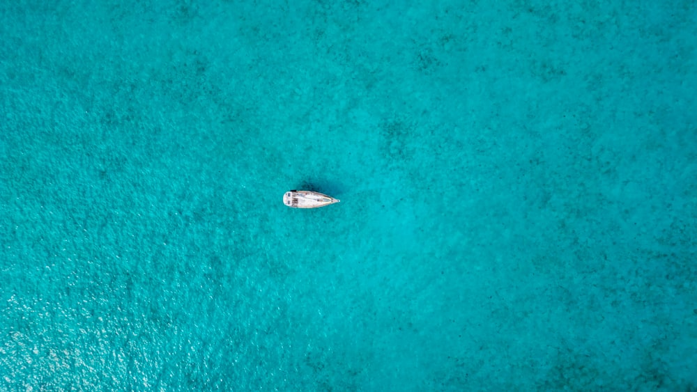 an aerial view of a boat in the ocean