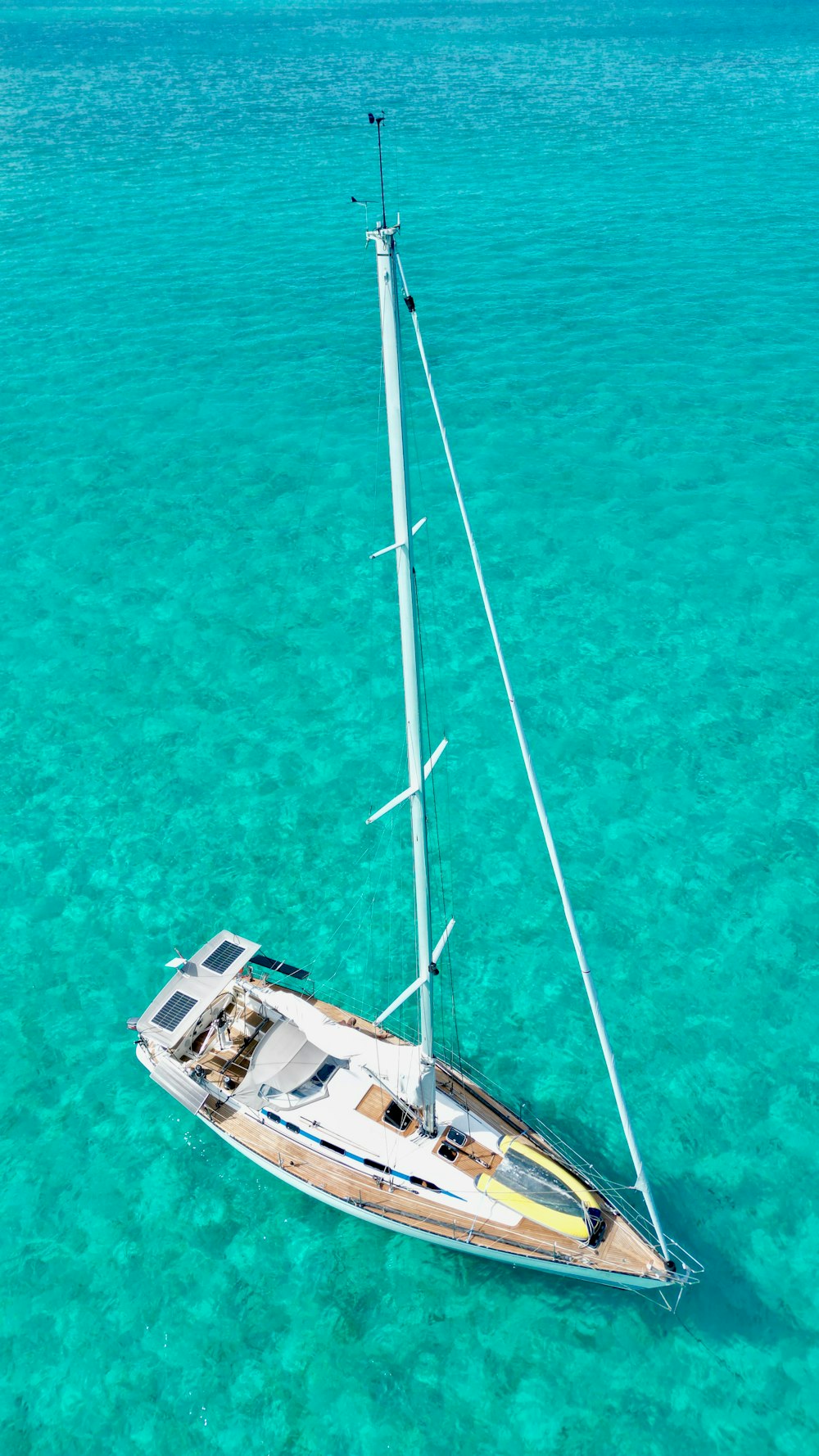 a sailboat floating in clear blue water