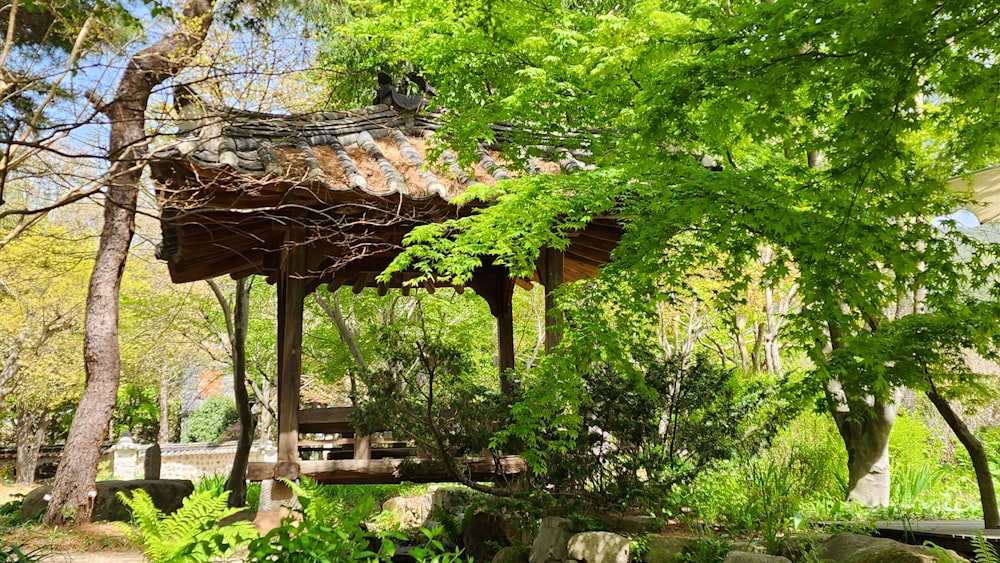 a gazebo in the middle of a lush green park