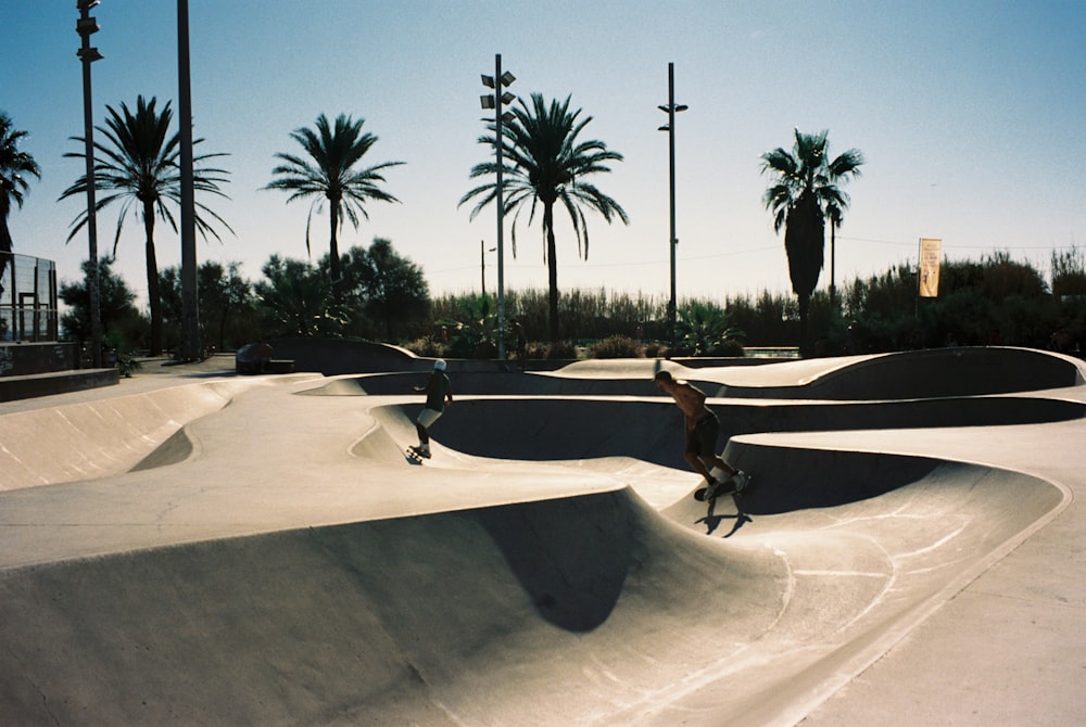 a group of people riding skateboards at a skate park