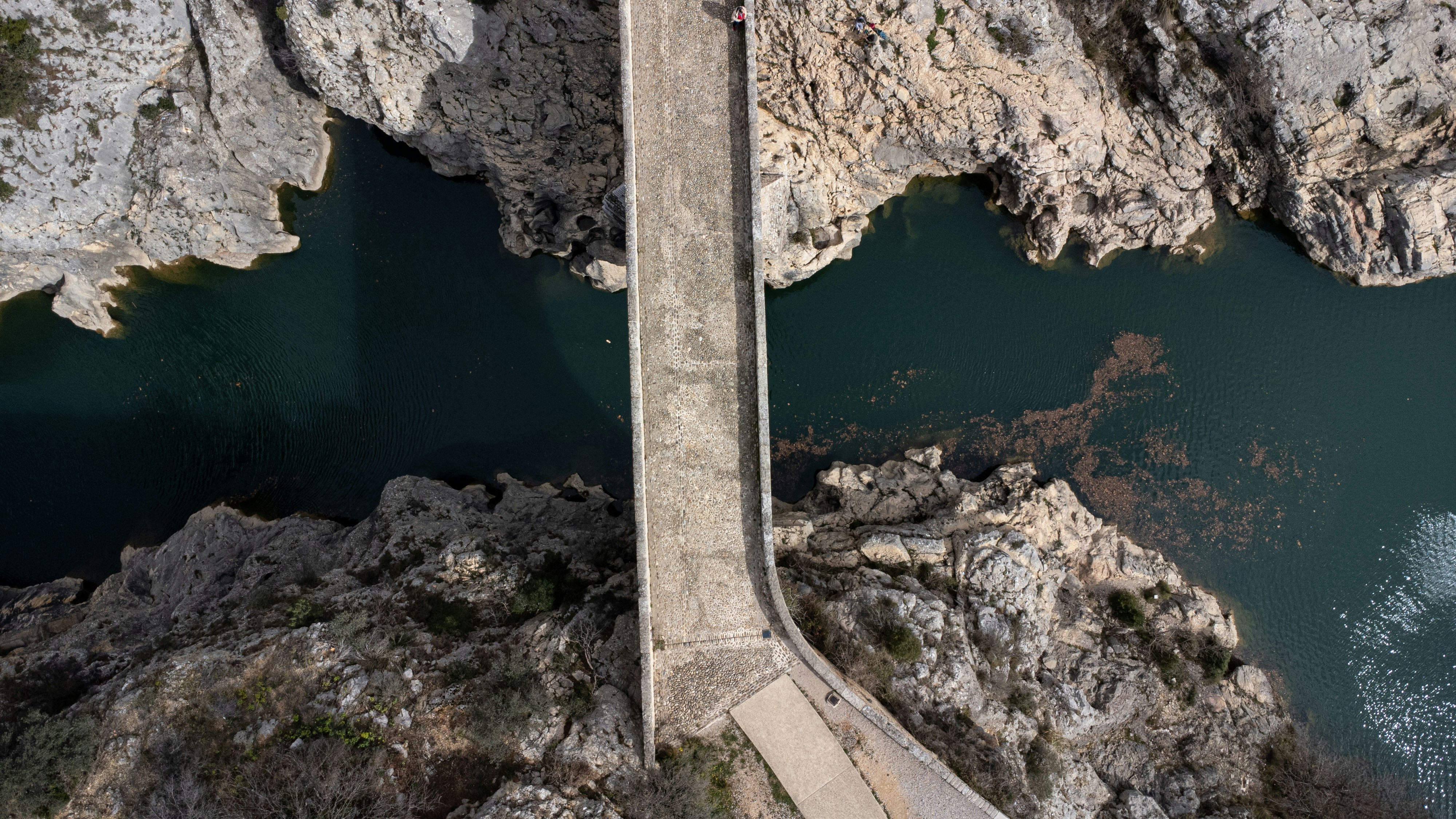 an aerial view of a bridge over a body of water