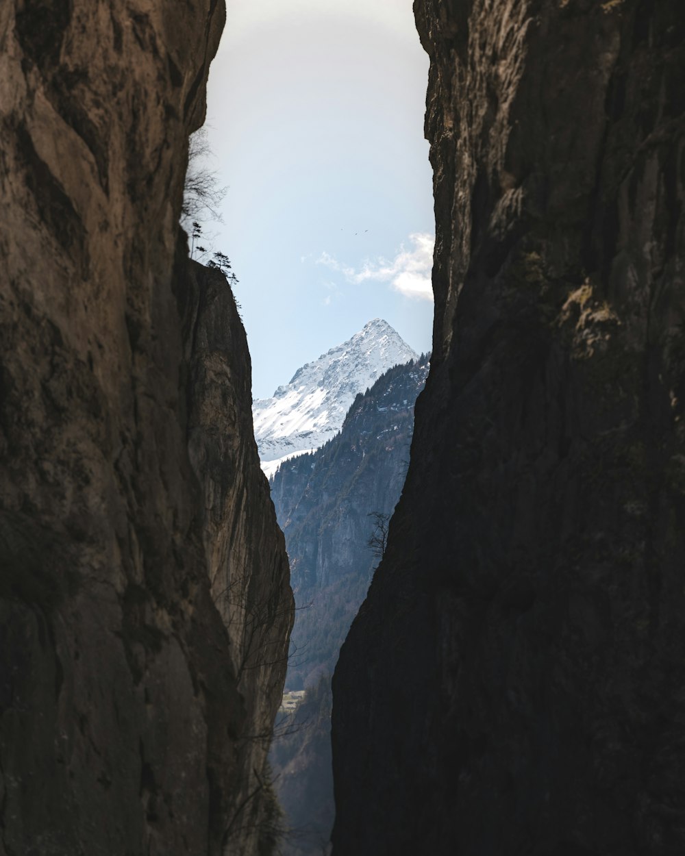 a view of a mountain through a narrow canyon