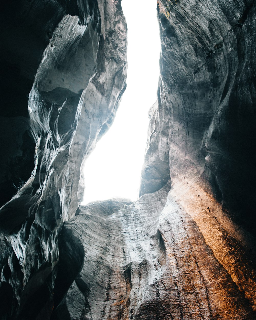 a narrow opening in the side of a rock formation