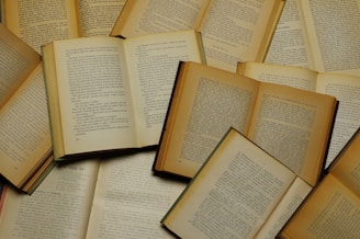 a pile of open books laying on top of each other