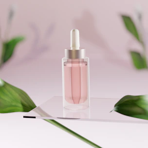 Elegant glass dropper bottle filled with a shimmering pink serum surrounded by rose petals.
