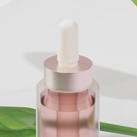 Close-up of a glowing serum bottle with a dropper surrounded by fresh green leaves.
