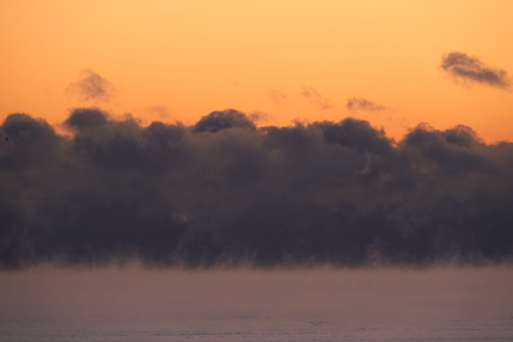 a large body of water under a cloudy sky