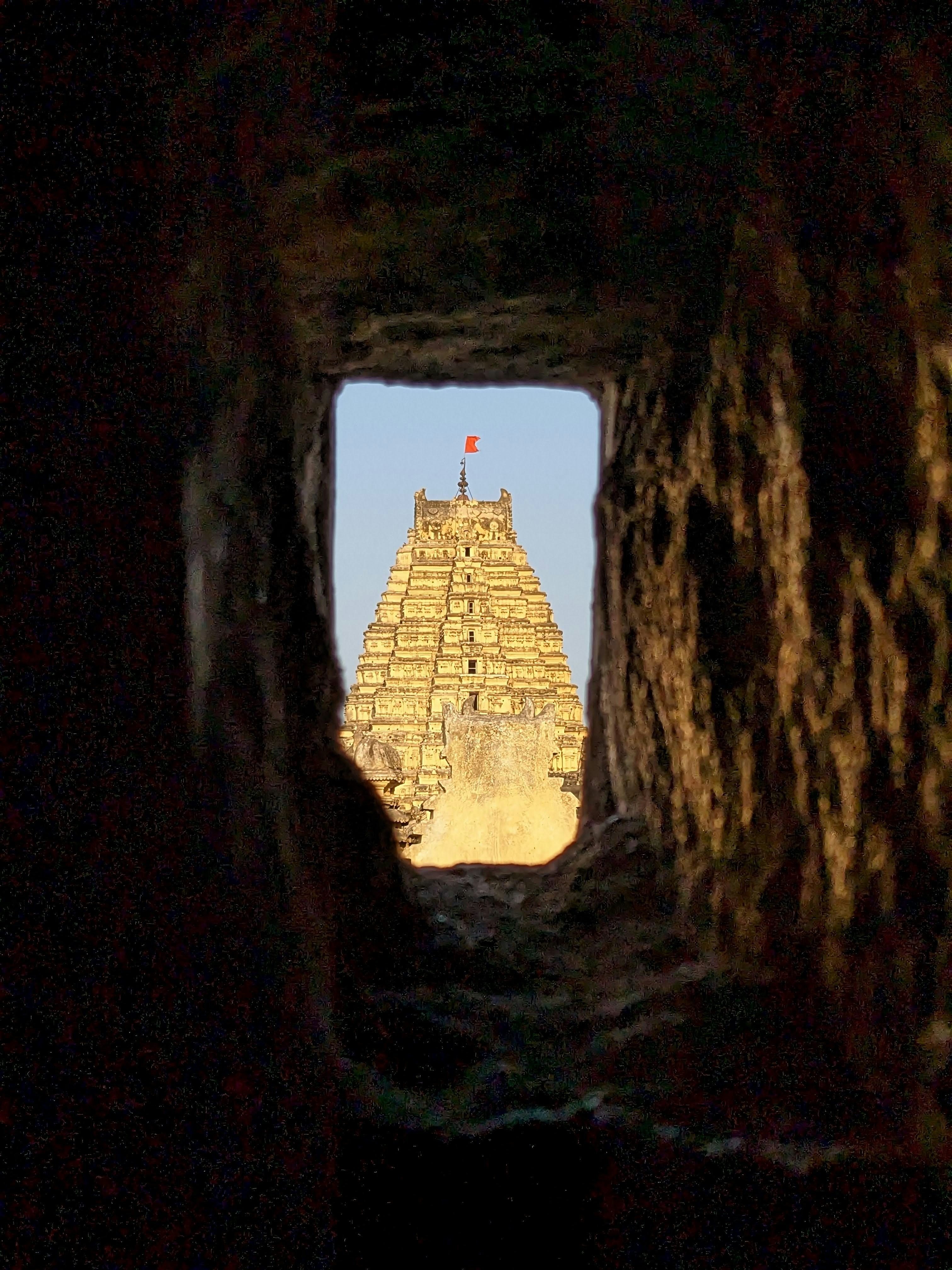 a view of a very tall building through a tunnel