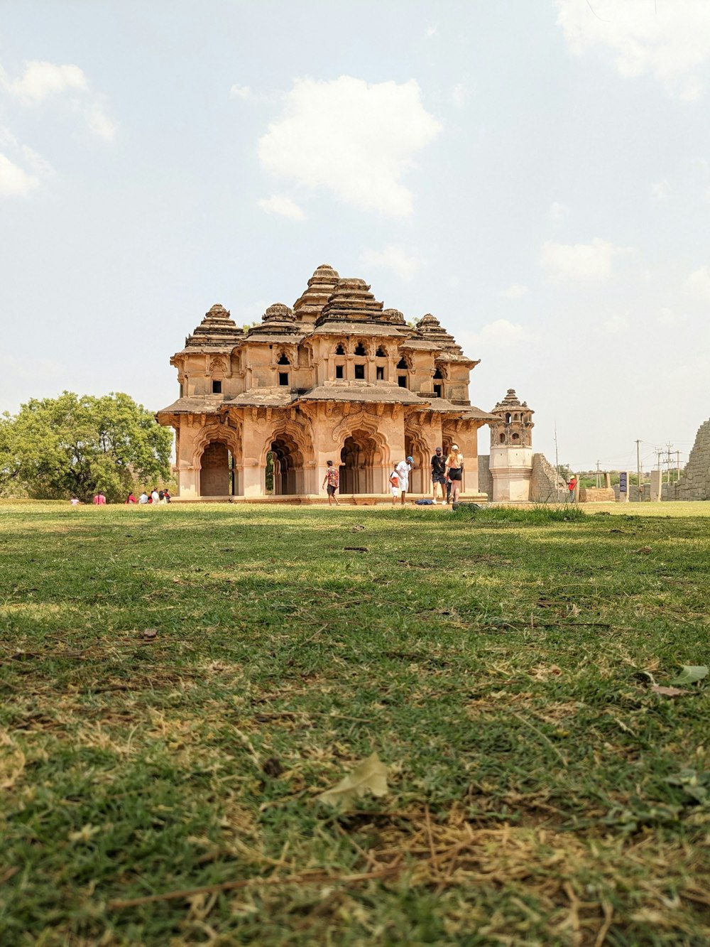 a large building sitting on top of a lush green field