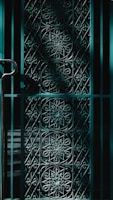 Close-up of a sturdy black metal gate with intricate geometric patterns.