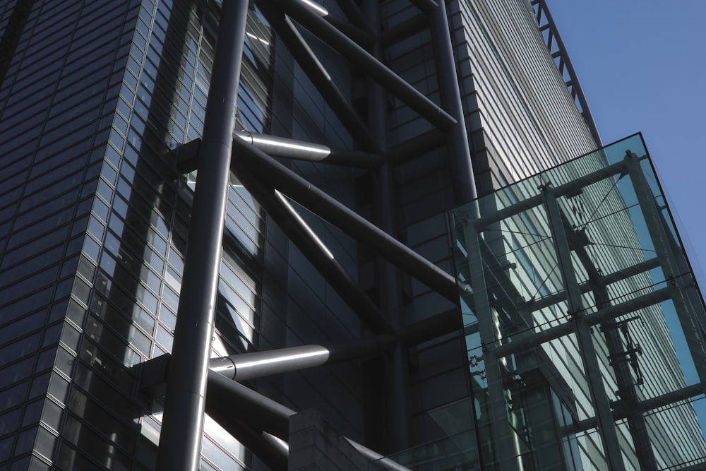 a glass and metal building with a clock on the side