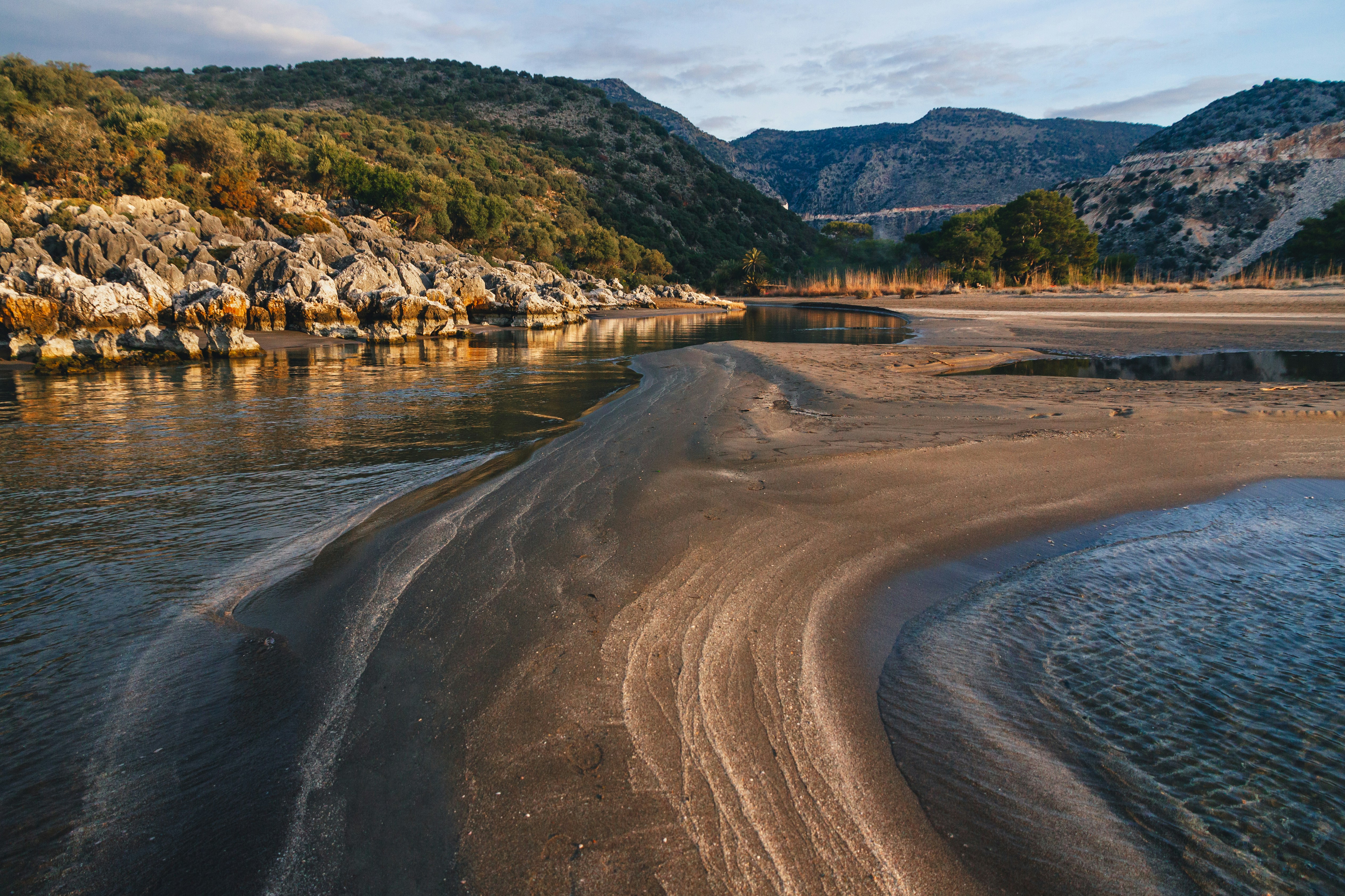 a body of water surrounded by mountains and trees