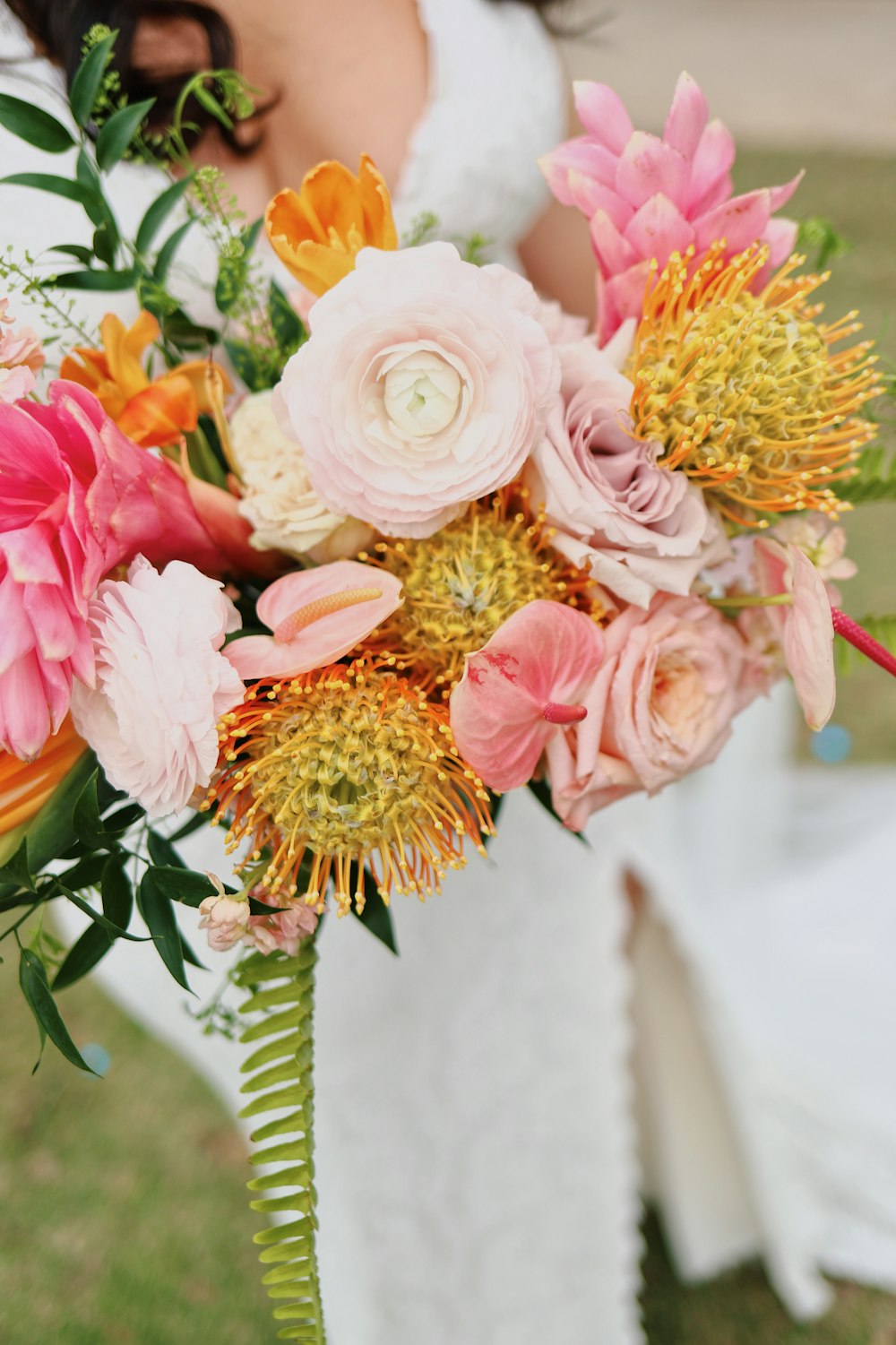 a bride holding a bouquet of flowers in her hand