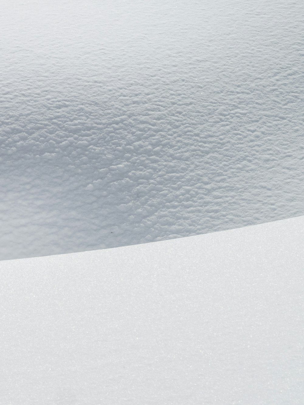 a man riding skis down a snow covered slope