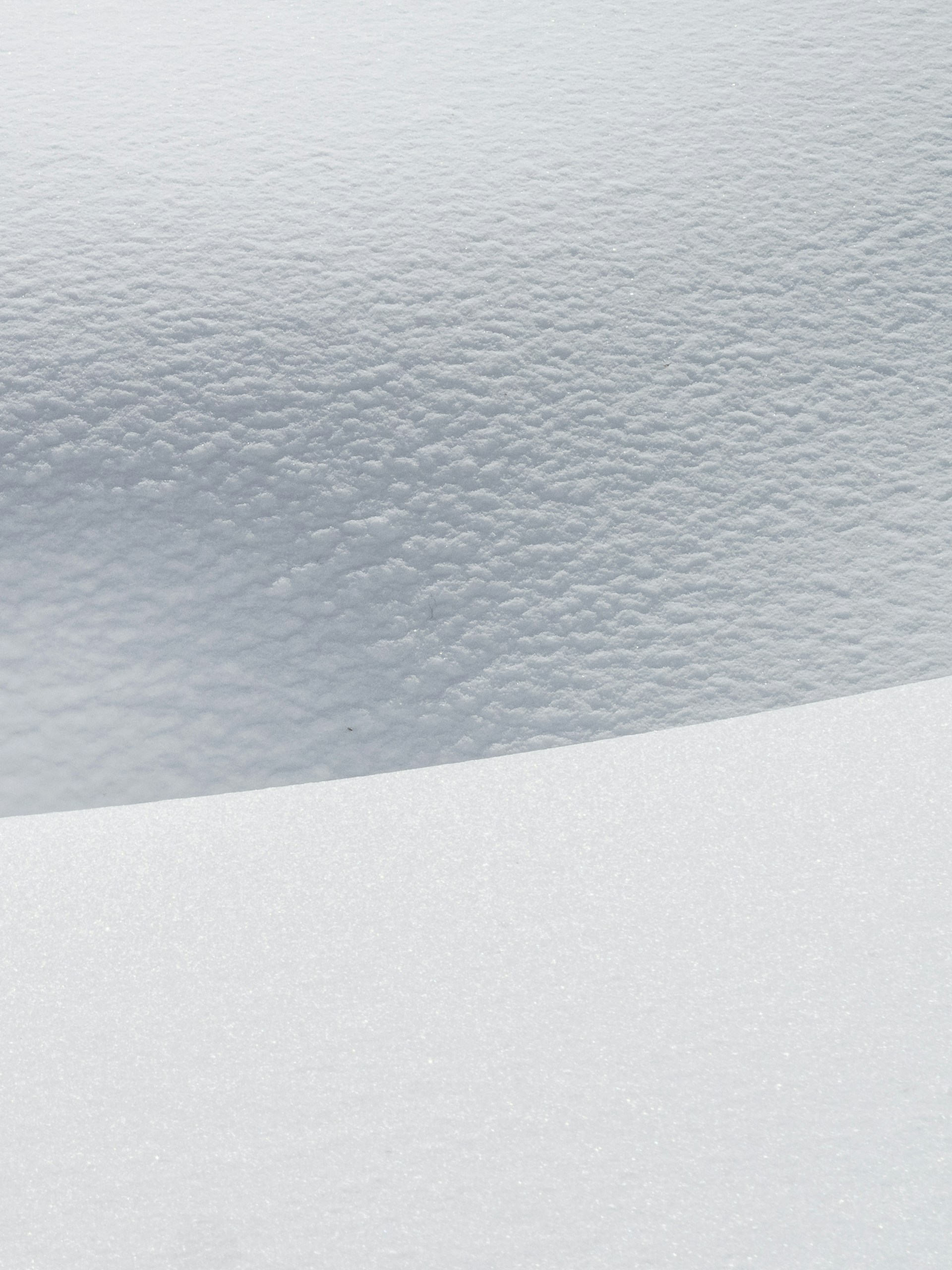 a man riding skis down a snow covered slope