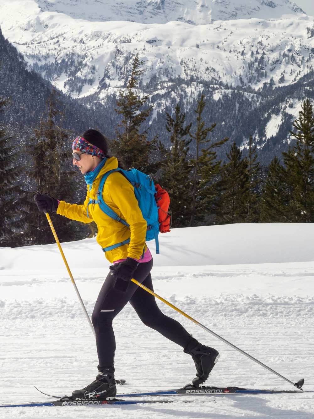 a person on skis in the snow with mountains in the background